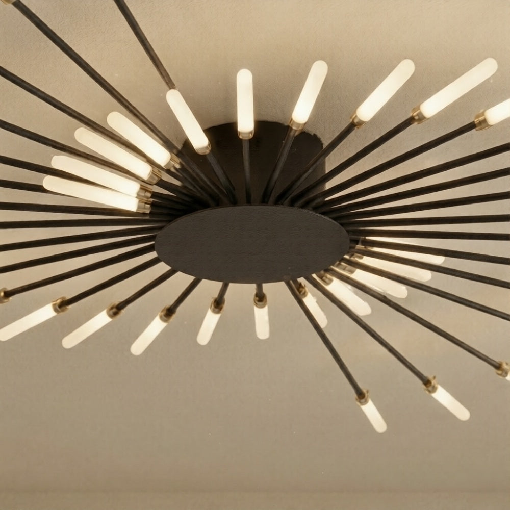 Close-up of wrought black iron and brushed gold detail on Spiral Starburst ceiling light