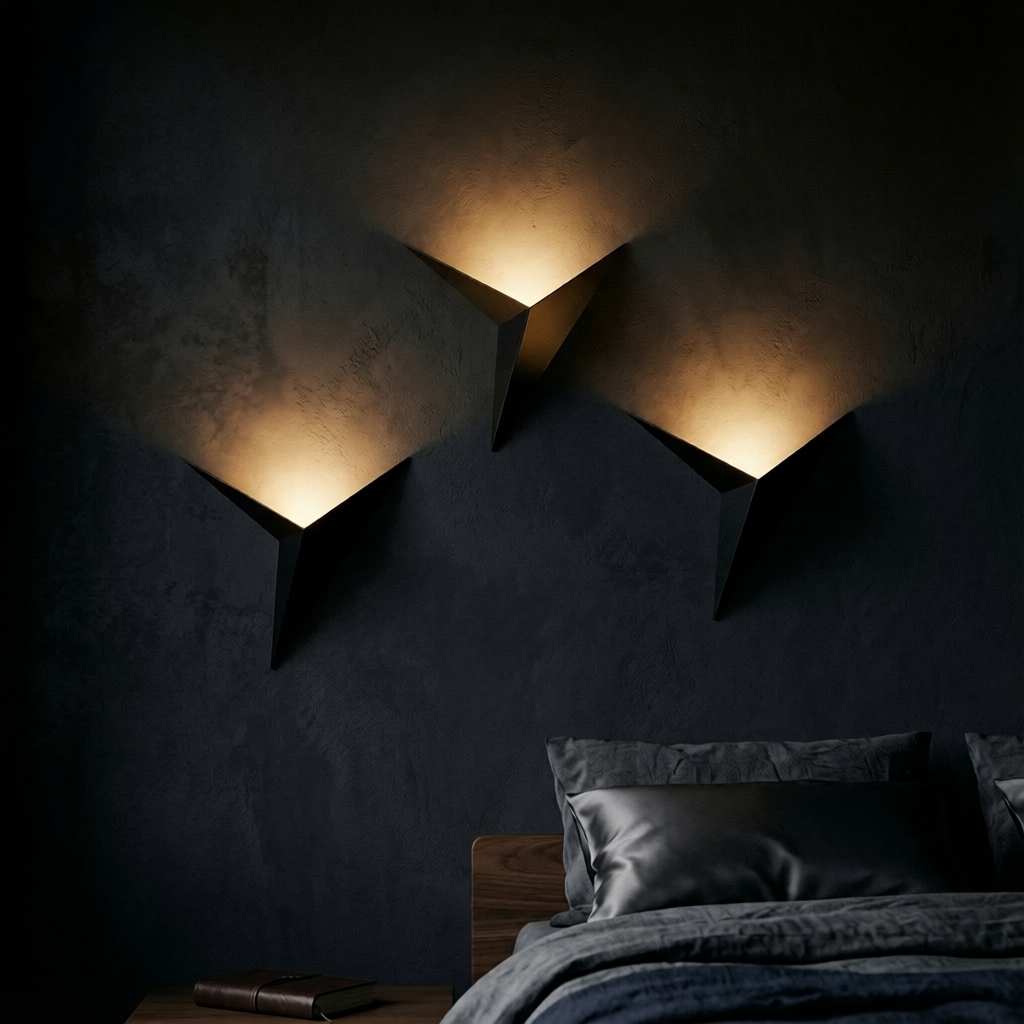 Two black geometric triangle wall lights with warm LED glow above bed