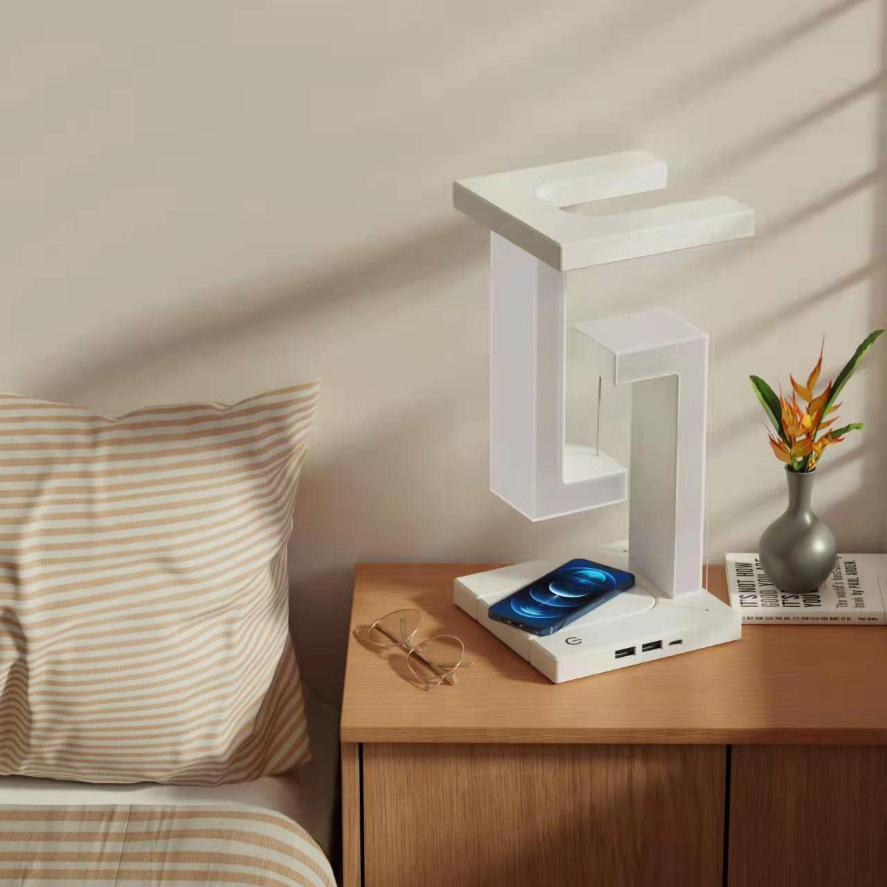 White levitating table lamp on bedside table natural daylight